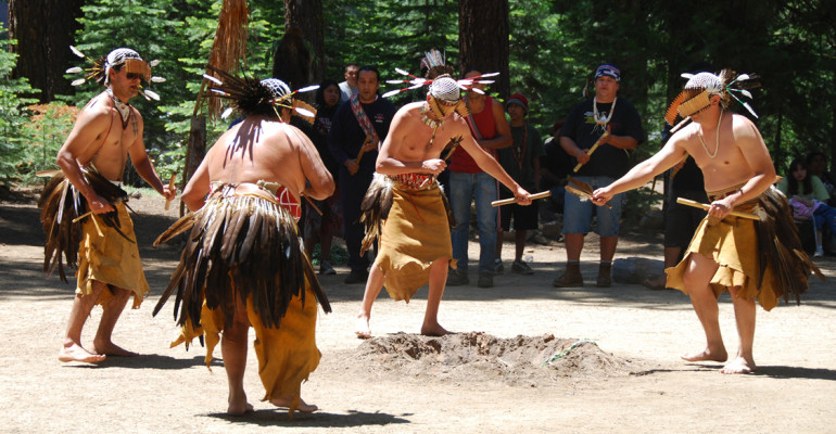 Five Native American men in traditional dance