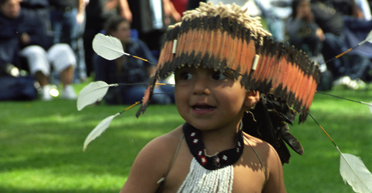 Native American young boy with headdress